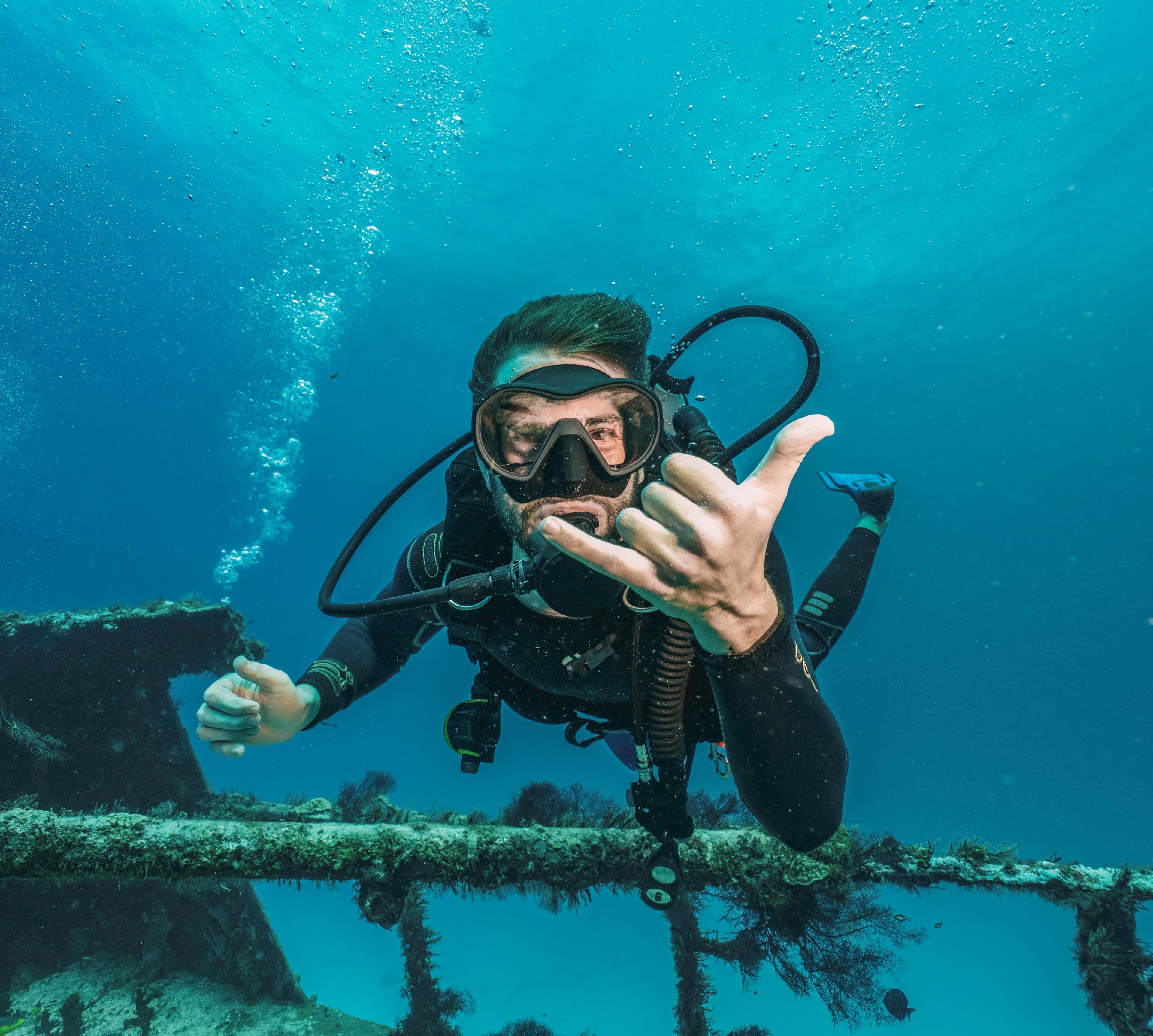 Professional scuba diver diving in a shipwreck Professional scuba diver diving in a shipwreck