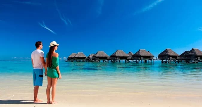 Guests walk along the beach Guests walk along the beach