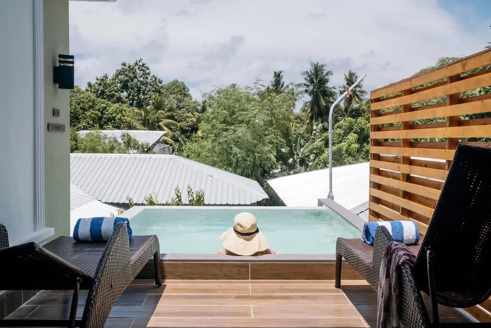 A relaxing swimming pool with two lounge chairs A relaxing swimming pool with two lounge chairs
