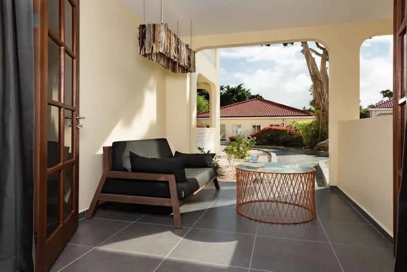 A sofa and table on a deck at Livingstone Jan Thiel Beach Resort A sofa and table on a deck at Livingstone Jan Thiel Beach Resort