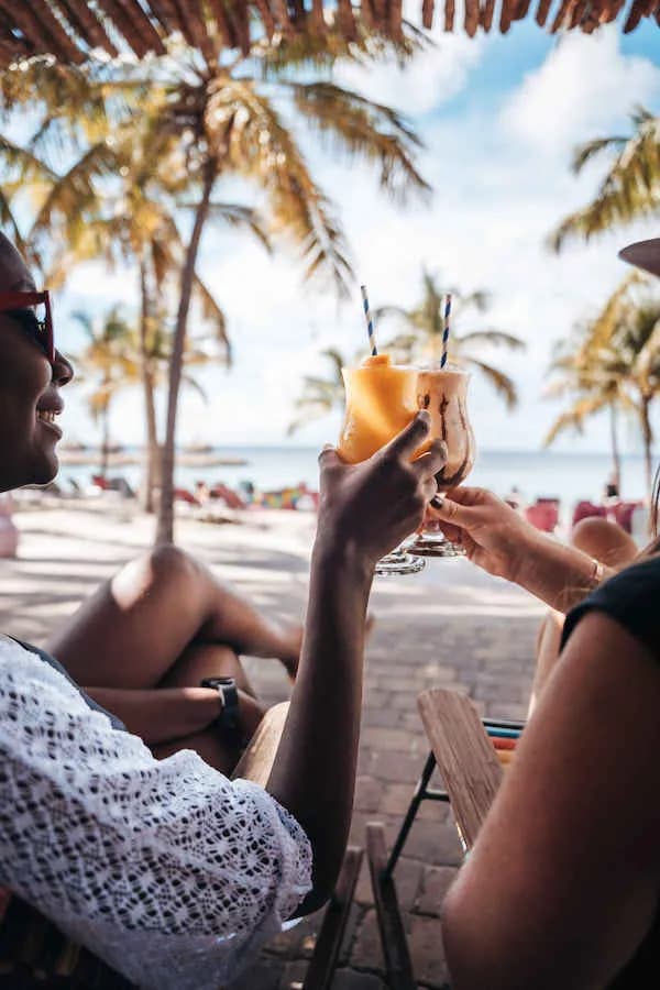 Guests enjoy a drink by the beach Guests enjoy a drink by the beach