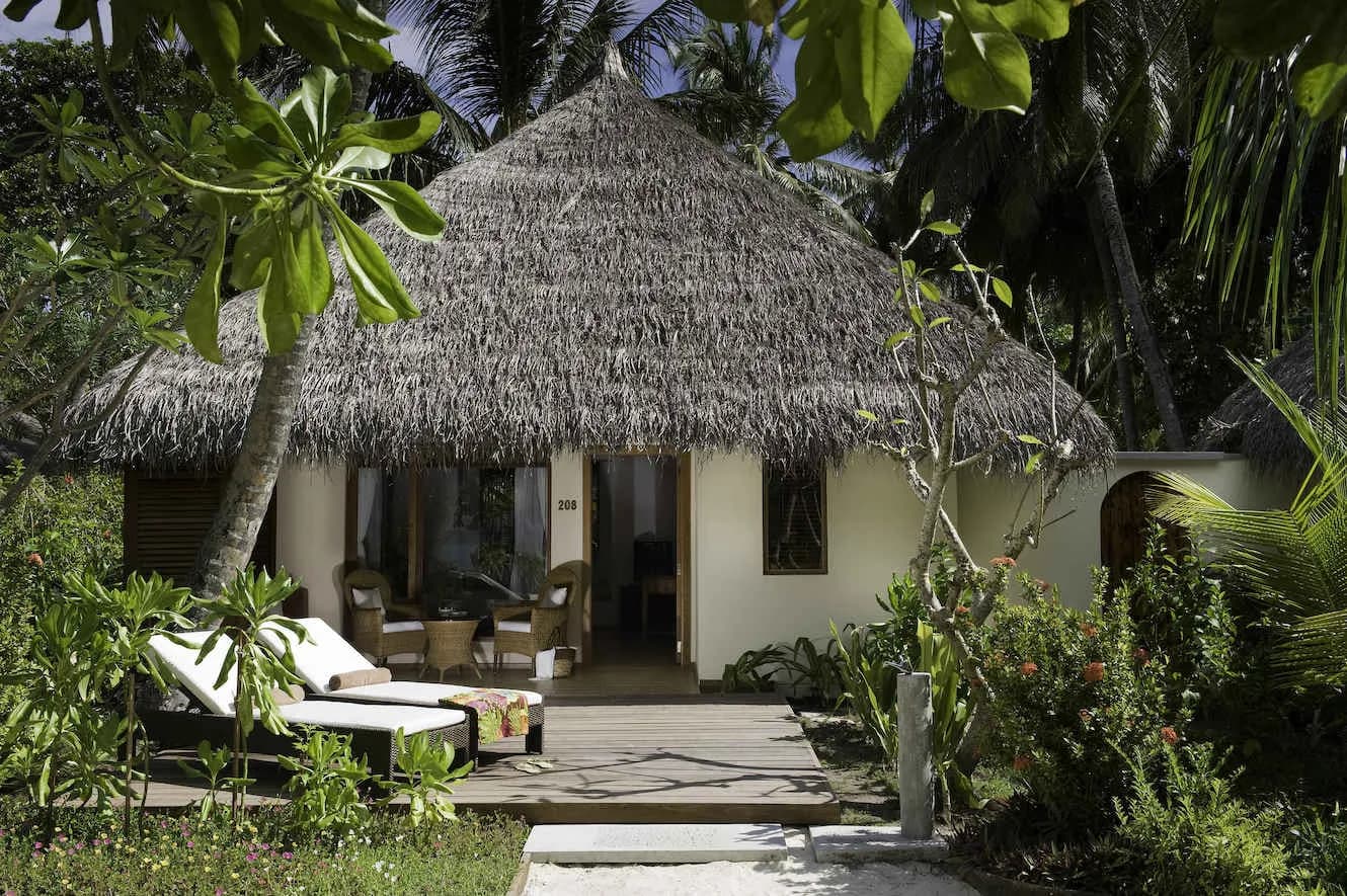 A deluxe beach villa is nestled in the jungle at Kuramathi Island Resort Maldives. A deluxe beach villa is nestled in the jungle at Kuramathi Island Resort Maldives.
