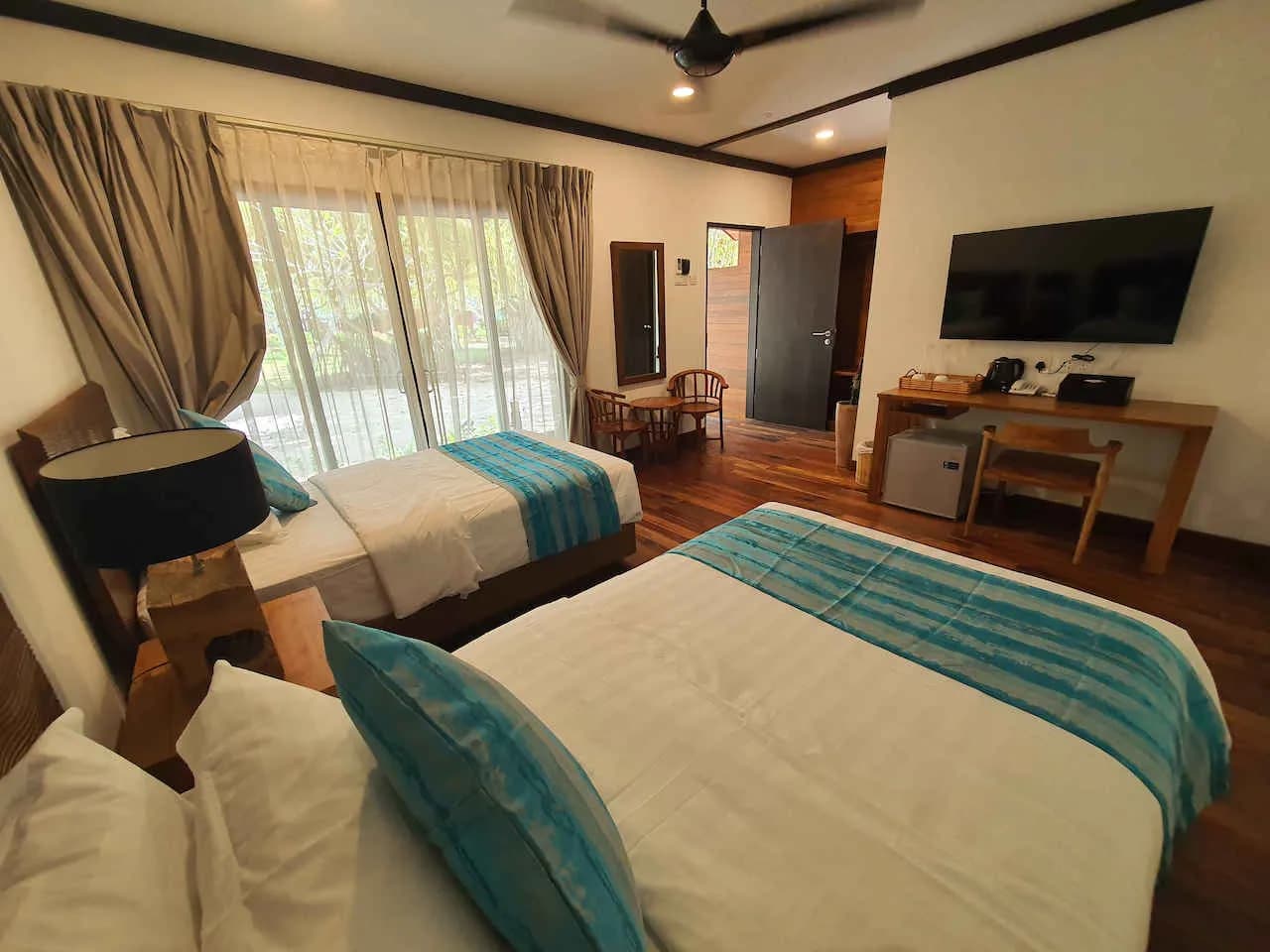 Twin beds in a room with a TV and desk Twin beds in a room with a TV and desk