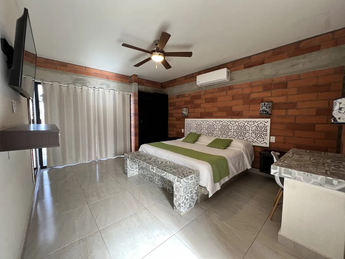 Suite with a large bed and television Suite with a large bed and television