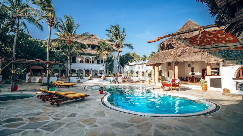 The swimming pool surrounded by lounge chairs The swimming pool surrounded by lounge chairs