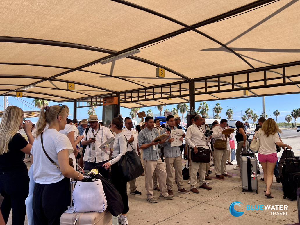 Drivers wait for their passengers under assigned numbers at Cabo Airport SJD