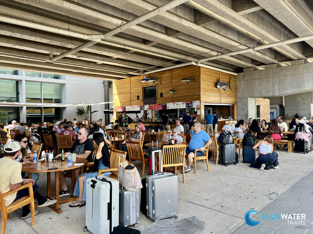 People enjoy food and drinks at the outdoor restaurants at Cabo Airport SJD