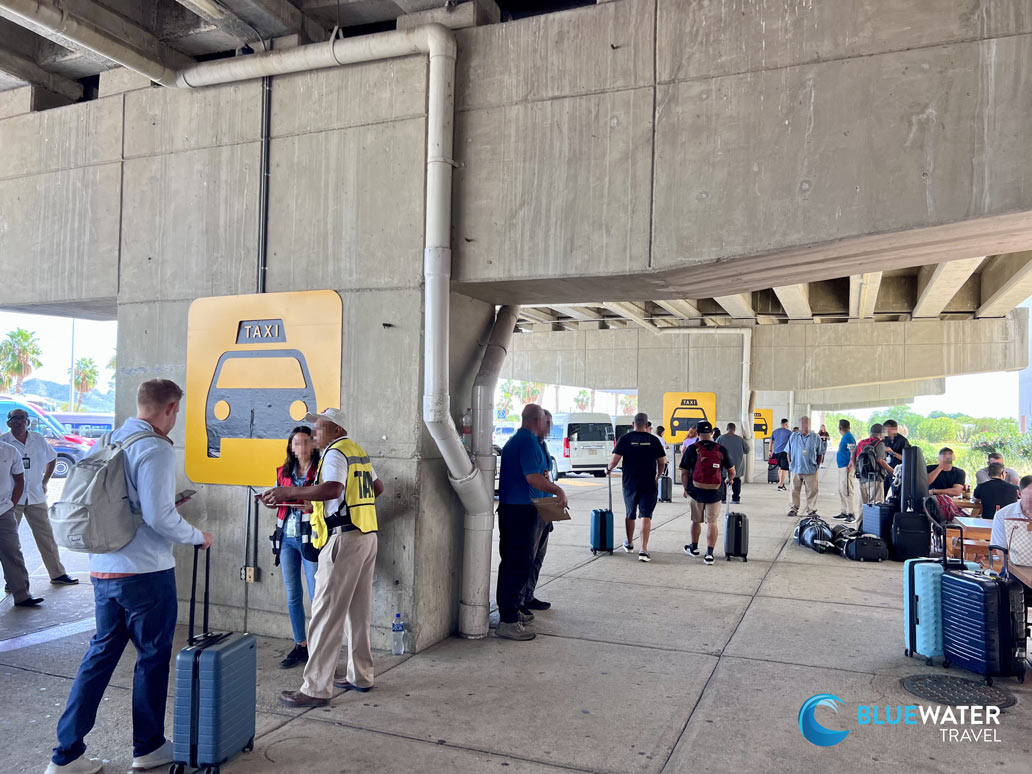 People wait at taxi stands at the Cabo Airport