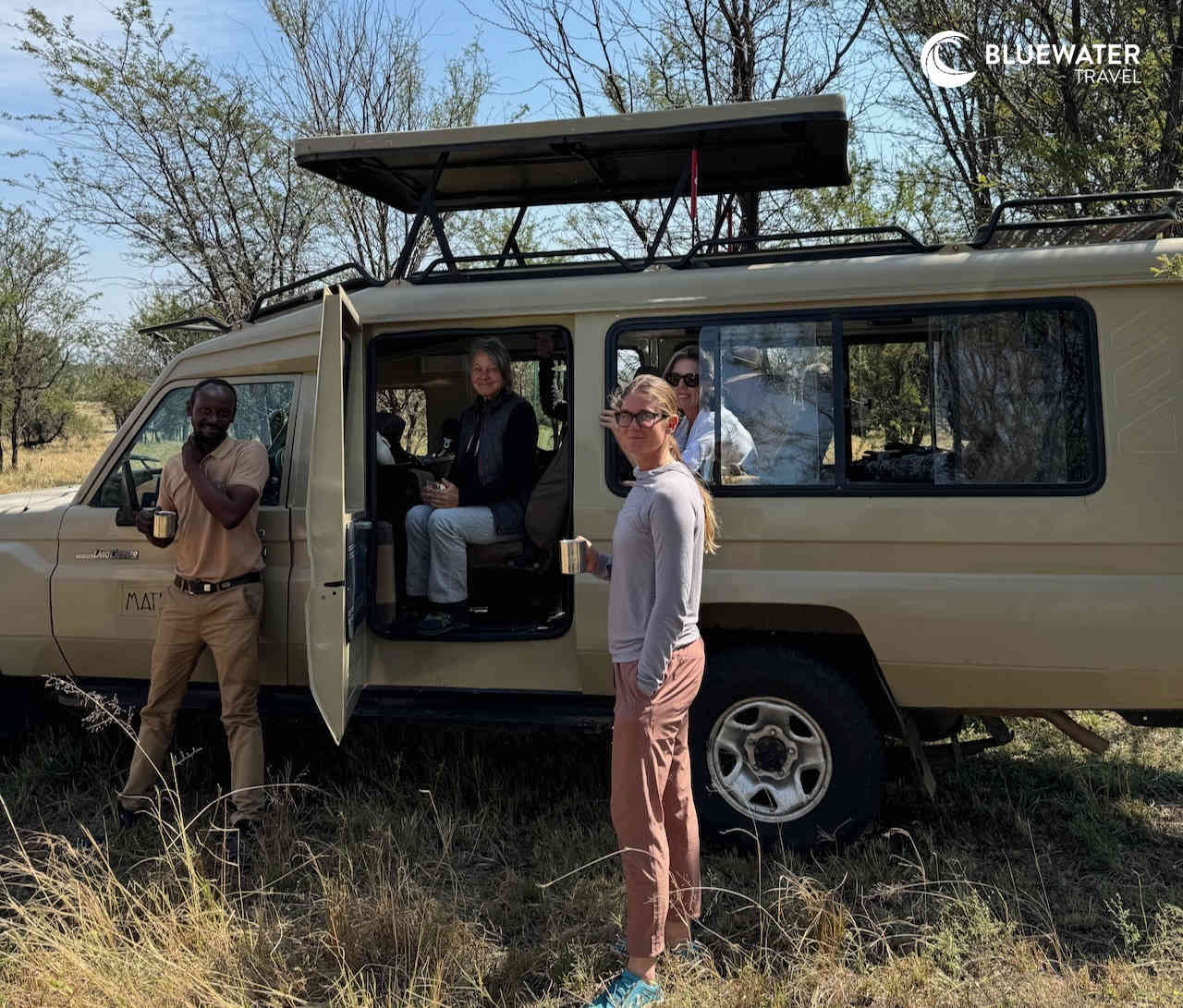 Guests around the 4x4 safari vehicle