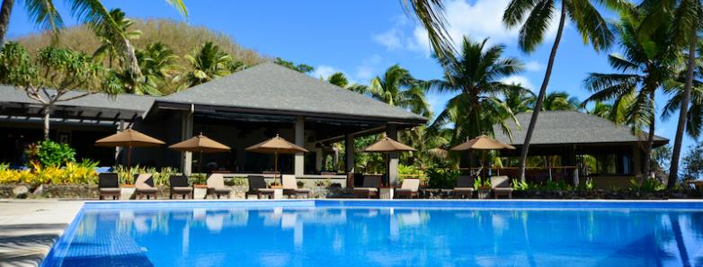 Swimming pool with cabanas in the background