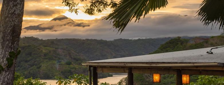 A terrace overlooking a beautiful sunset at Tufi Resort