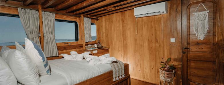 Master cabin with large bed and windows