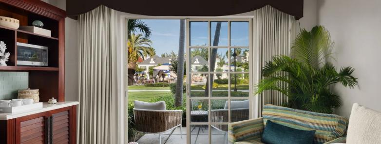 Bed with terrace opening up to the gardens in the Luxury Walkout Room