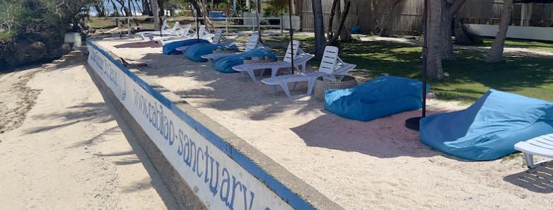 Cabilao Sanctuary's beachfront with bean bags and sunbeds