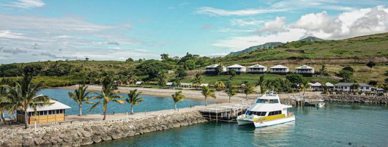 The Duadua Beach Resort with a yacht docked in front