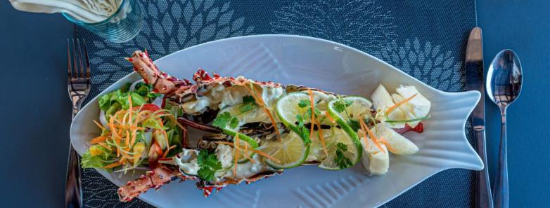 Delicious meal laid atop a fish-shaped plate