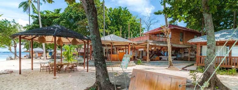 Beachfront of the resort with hammocks and couches