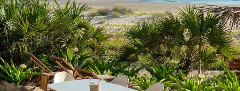 Chairs and tables set up in the sand