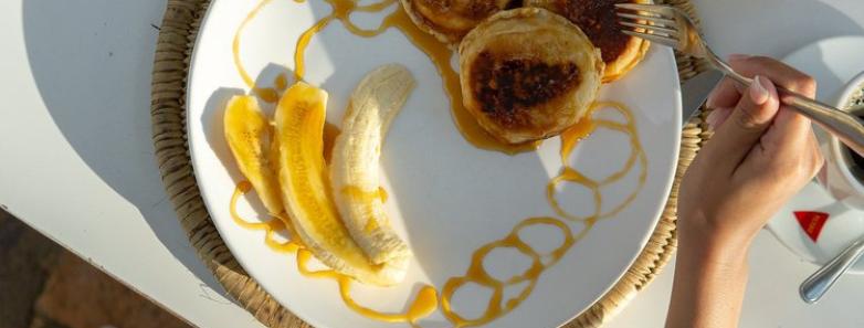 A guest eats a delicious breakfast served at HAPPI