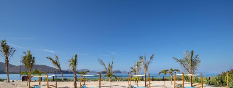 The beachfront with lounge areas and beds