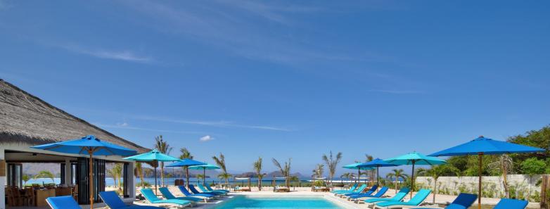 Swimming pool surrounded by lounge chairs