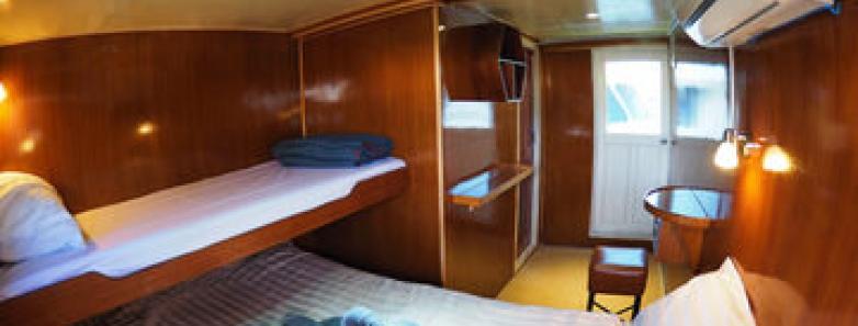 Master Cabin's beds for three divers with a sea view