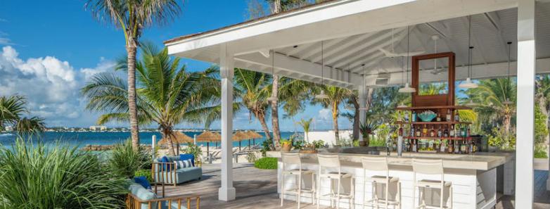 A bar with high chairs next to the gardens