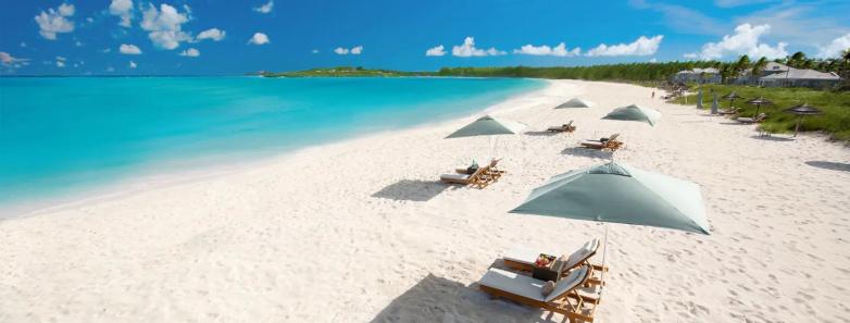 Lounge chairs with umbrellas on the beachfront