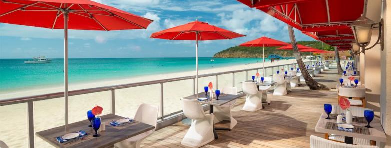 Dining chairs and tables set up by the beach