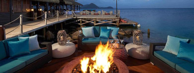 A bonfire surrounded by lounges