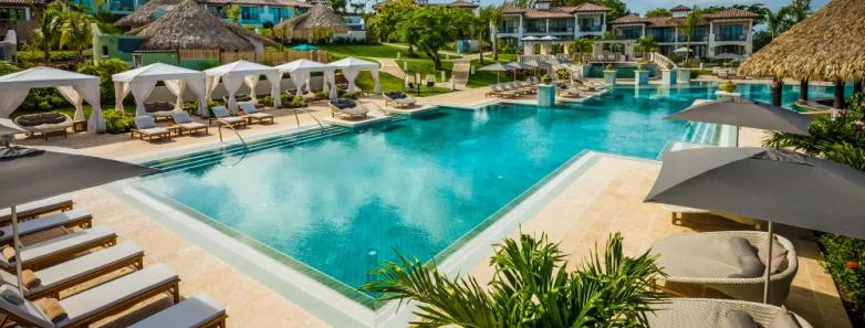 Large rectangular pool with sun beds surrounding it