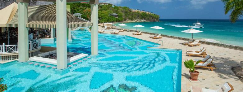 A swimming pool surrounded by shaded lounge chairs