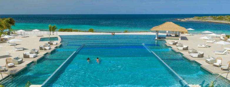 The Sandals pool with chairs alongside it