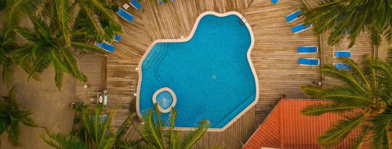 An aerial shot of the swimming pool with sunbeds around it