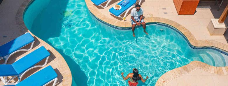 An aerial shot of the swimming pool surrounded by sunbeds