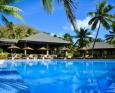 Swimming pool with cabanas in the background